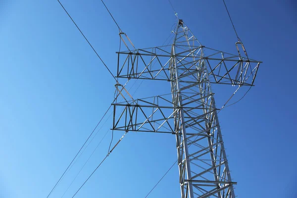 Modern high voltage tower against blue sky