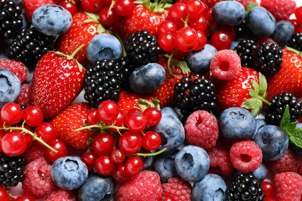 Mix of fresh delicious berries as background, top view