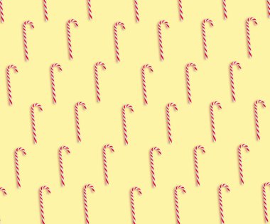 Soluk sarı arka planda Noel şeker kamışları deseni, üst manzara