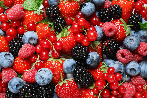 Mix of fresh delicious berries as background, top view