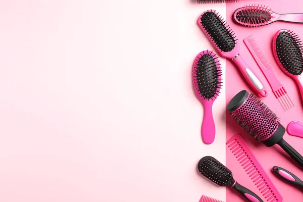 Different hair brushes and combs on color background, flat lay. Space for text