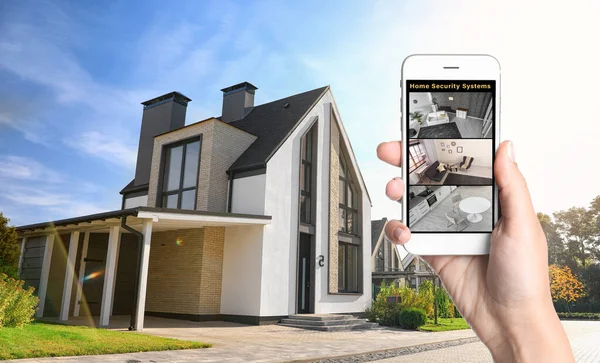 Alarm system. Woman monitoring modern CCTV cameras on smartphone near her house, closeup