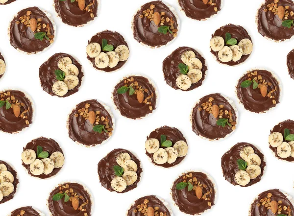 Set of puffed corn cakes with chocolate spread on white background, top view. Pattern design