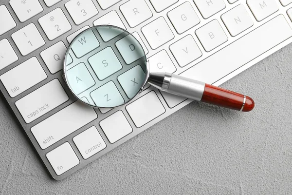 Magnifier Glass Keyboard Light Grey Stone Background Top View Find — Stock Photo, Image