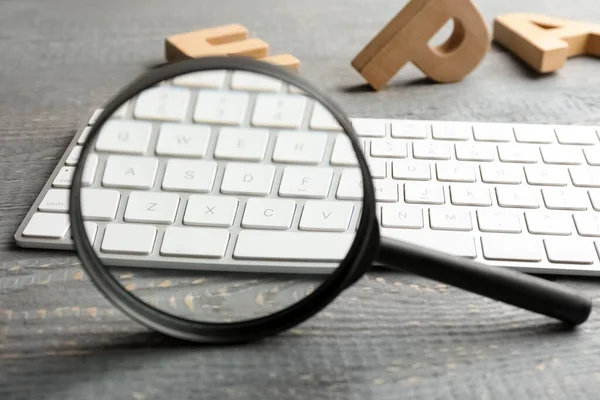 Magnifier Glass Keyboard Letters Light Grey Wooden Table Closeup Find — Stock Photo, Image