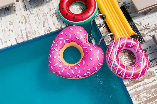 Above view of inflatable rings and swimming pool. Summer vacation