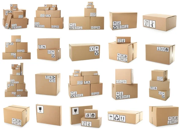 Set of cardboard boxes with packaging symbols on white background