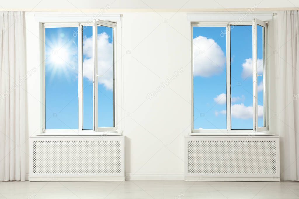 Beautiful view on blue sky with clouds through windows in room