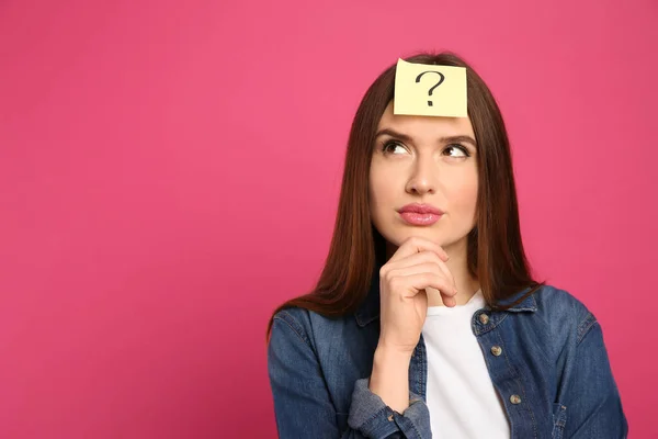 Umsichtige Frau Mit Fragezeichen Aufkleber Auf Der Stirn Vor Rosa — Stockfoto