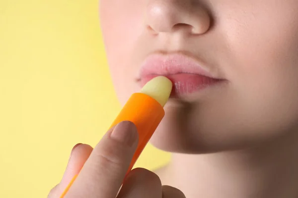 Woman Applying Hygienic Lipstick Lips Yellow Background Closeup — Stock Photo, Image