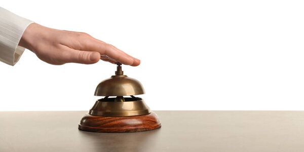 Woman ringing hotel service bell at grey stone table
