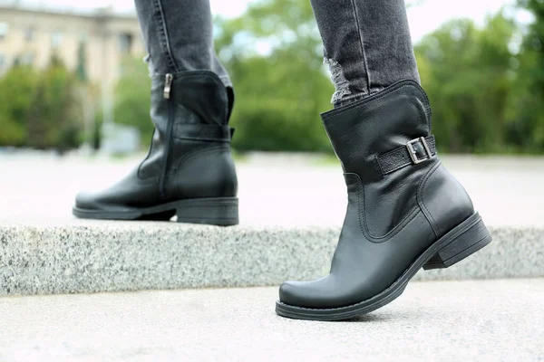 Woman wearing comfortable stylish boots outdoors, closeup