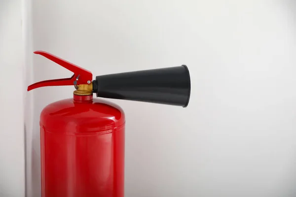 Fire extinguisher on white background, closeup. Space for text