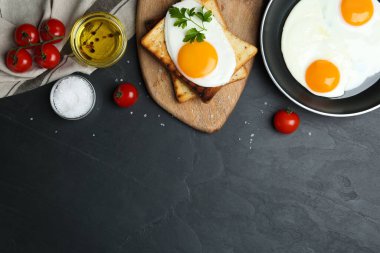 Düz kompozisyon ve siyah masanın üzerinde leziz sahanda yumurta. Metin için boşluk