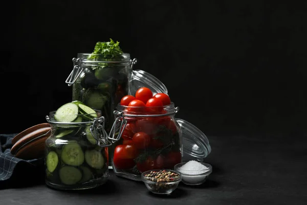 Pickling jars with fresh ripe vegetables and spices on black table. Space for text — Stock Image Pickling Jars Fresh Ripe Vegetables Spices Black Table Space Text Stock Image