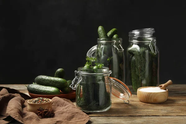 Pickling jars with fresh ripe cucumbers and spices on wooden table — Stock Image Pickling Jars Fresh Ripe Cucumbers Spices Wooden Table Royalty Free Stock Images