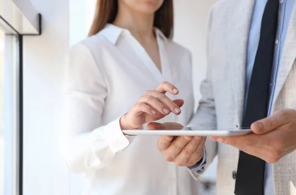 Business people working with modern tablet in office, closeup