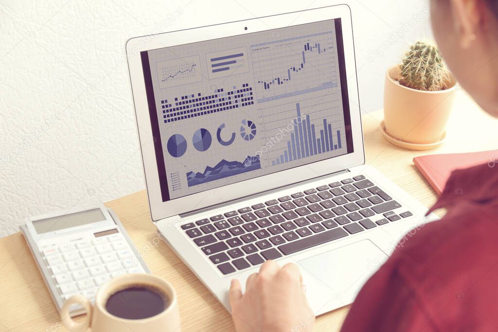 Woman using laptop in office, closeup. Fintech concept