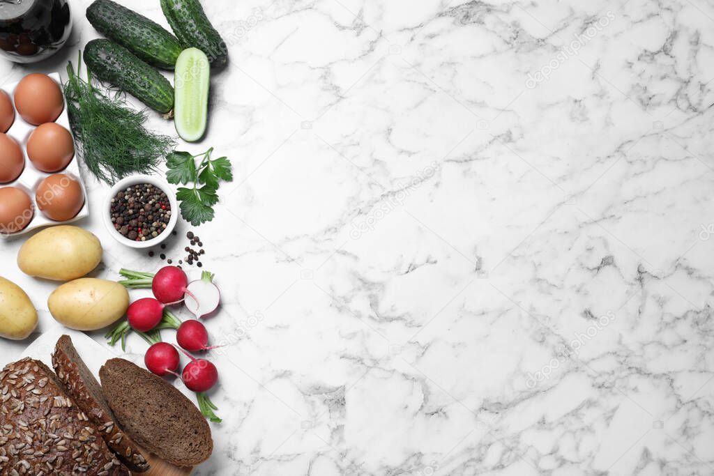 Flat lay composition of soup ingredients on white marble table, space for text. Traditional Russian summer okroshka