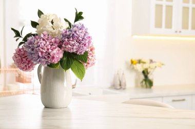 Bouquet with beautiful hydrangea flowers on white marble table. Space for text clipart