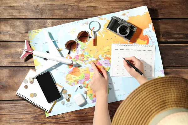 Woman Marking Calendar Table World Map Top View Travel Summer — Stock Photo, Image