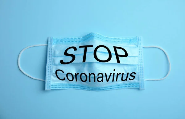 Medizinische Maske Mit Text Coronavirus Stoppen Auf Hellblauem Hintergrund Schutzmaßnahmen — Stockfoto