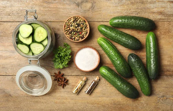 Pickling jar with fresh ripe cucumbers and spices on wooden table, flat lay — Stock Image Pickling Jar Fresh Ripe Cucumbers Spices Wooden Table Flat Lay Royalty Free Stock Photos