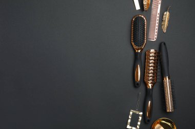 Düz kompozisyon ve siyah arka planda modern saç fırçaları. Metin için boşluk
