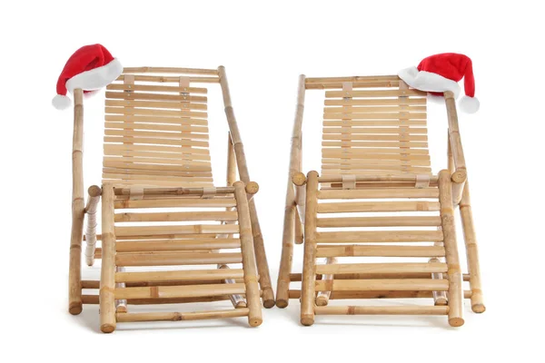 木制的甲板椅子和白色背景的圣诞老人帽 圣诞假期 — 图库照片