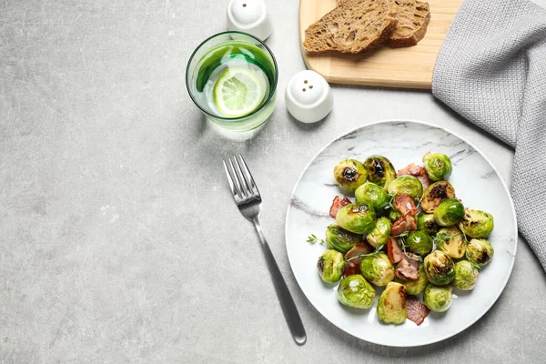 Heerlijke Gebakken Spruitjes Met Spek Geserveerd Grijze Tafel Plat Gelegd — Stockfoto