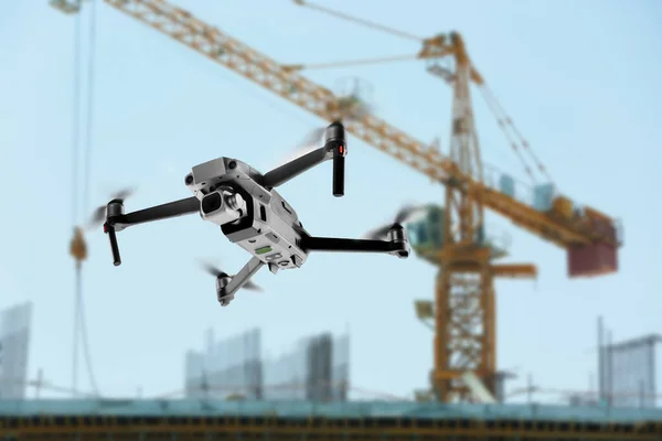 Modern drone flying at building site. Aerial survey