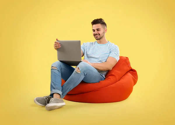 Jovem Com Laptop Cadeira Saco Feijão Fundo Amarelo — Fotografia de Stock