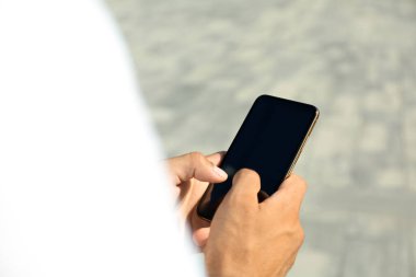 Modern cep telefonunu kullanan adam, yakın plan.