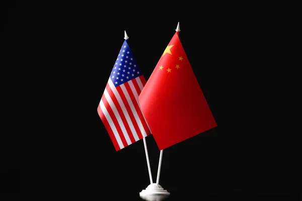 USA and China flags against black background. International relations