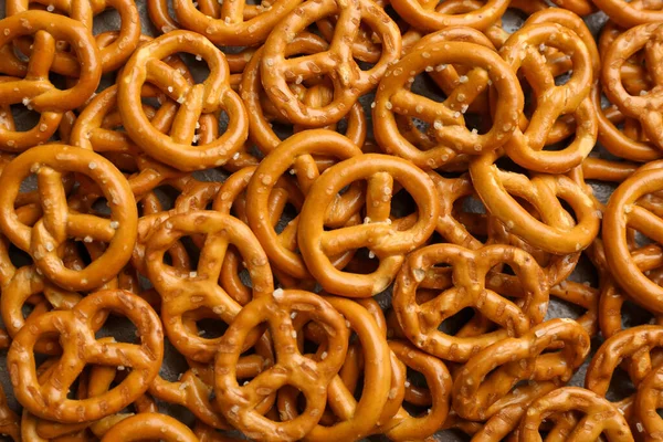 Many Delicious Pretzel Crackers Background Top View — Stock Photo, Image