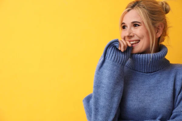 Happy woman in stylish sweater on yellow background. Space for text