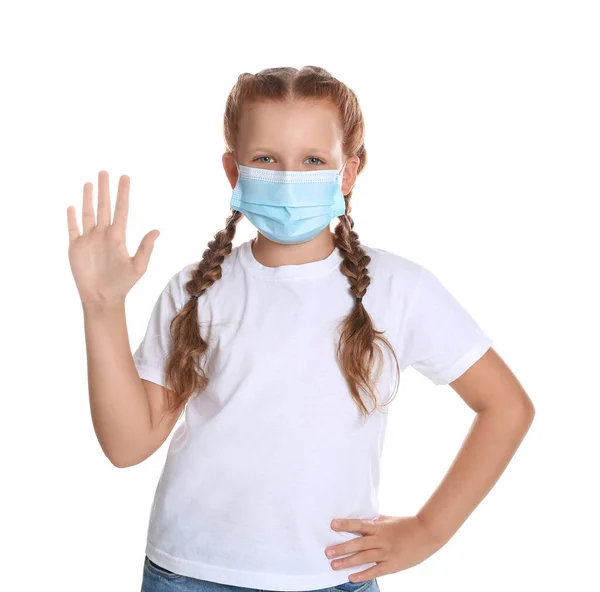 戴防护面具的小女孩在白色背景上表现出打招呼的姿势 在大肠病毒大流行期间保持社会距离 — 图库照片