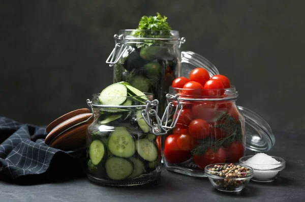 Pickling jars with fresh ripe vegetables and spices on black table — Stock Image Pickling Jars Fresh Ripe Vegetables Spices Black Table Stock Photo