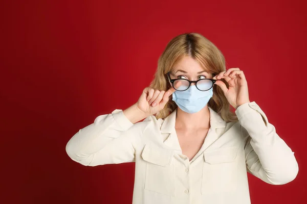 Woman Wiping Foggy Glasses Caused Wearing Medical Mask Red Background — Stock Photo, Image