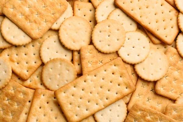 Veel Heerlijke Crackers Als Achtergrond Bovenaanzicht — Stockfoto