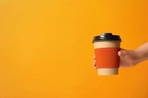 Woman Holding Takeaway Paper Coffee Cup Cardboard Sleeve Orange Background — Stock Photo, Image