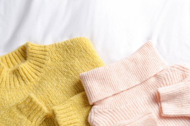 Beyaz kumaştan örülmüş süveterler, düz bir döşeme