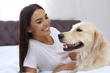Evinde sevimli köpeğiyle mutlu bir kadın.