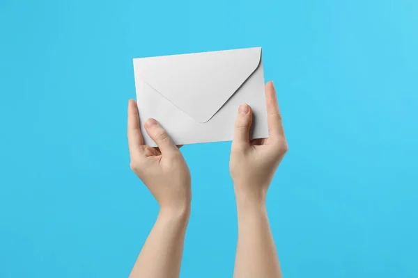 Woman Holding White Paper Envelope Light Blue Background Closeup — Stock Photo, Image