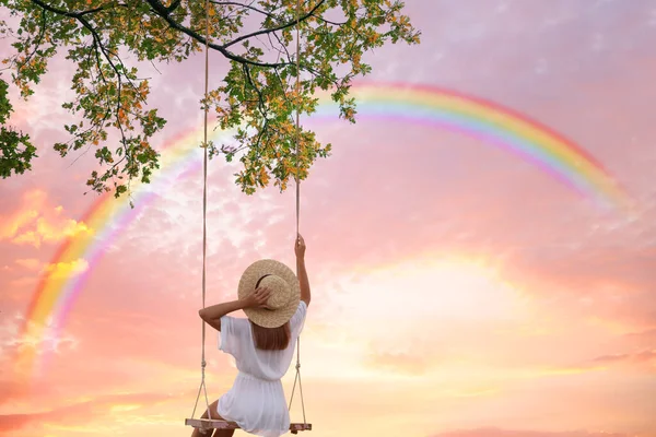 Dream World Young Woman Swinging Rainbow Sunset Sky Background — Stock Photo, Image