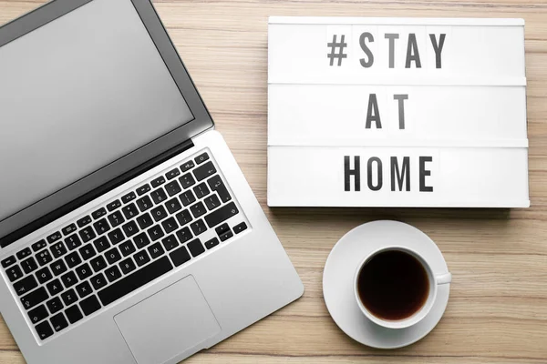 Laptop Kaffeetasse Und Leuchtkasten Mit Hashtag Stay Home Auf Holzgrund — Stockfoto