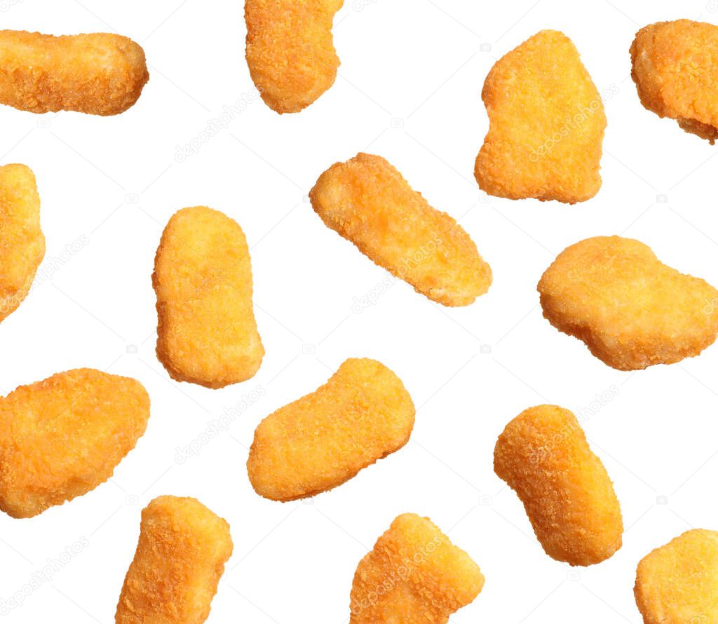 Fresh chicken nuggets falling on white background