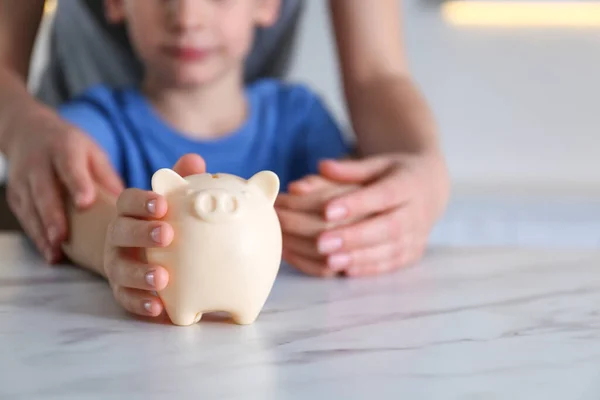 Mother Son Piggy Bank Marble Table Indoors Closeup — Stock Photo, Image