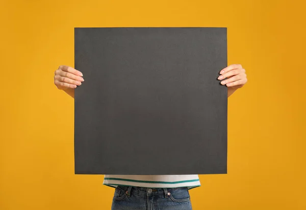 Woman Holding Black Blank Poster Yellow Background Mockup Design — Stock Photo, Image