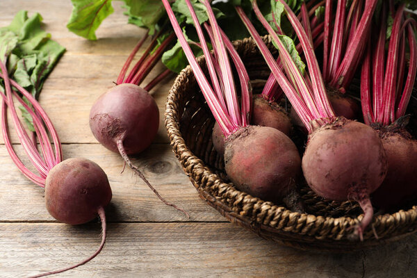 Many raw ripe beets on wooden table